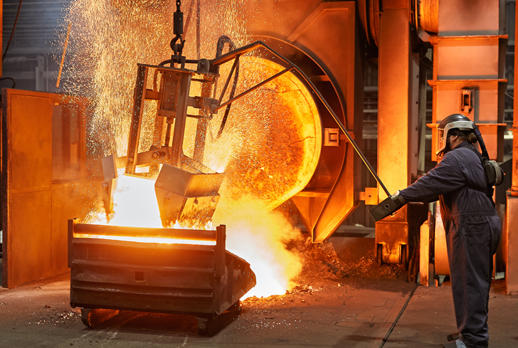 Cast Iron Foundry Operator deslagging molten iron bath 