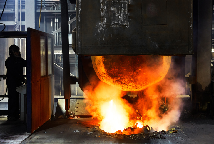 Cast iron foundry operators collaborating near the molding line (black and white photo) 