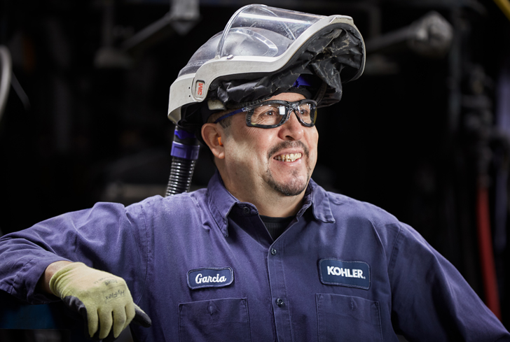 Color photo of Cast iron foundry operator smiling