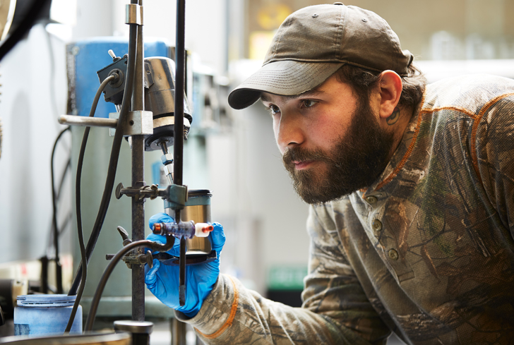 Foundry lab technician reviewing the green sand process to ensure quality output 