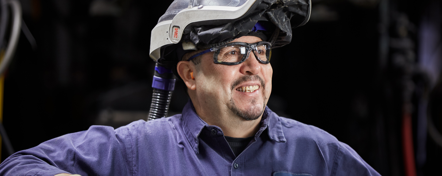 Color photo of Cast iron foundry operator smiling
