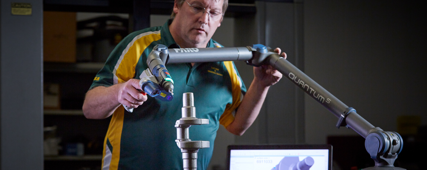 Foundry technician operating a 3D scanner to conduct a comprehensive review of cast iron parts.