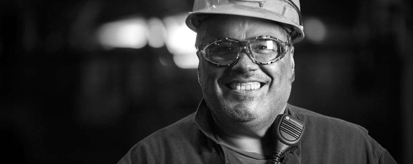 Black and white photo of cast Iron Foundry operator smiling and content